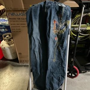 Blue jeans with butterfly sewn into it